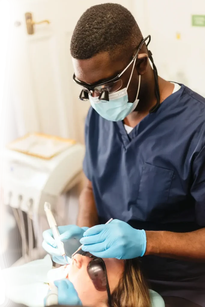 Dentist performing a dental procedure on a patient in a clinic.