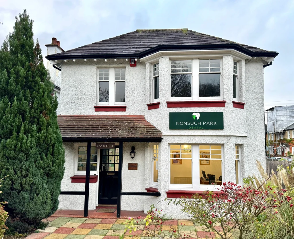 Nonsuch Park Dental practice with signage and greenery in the foreground.